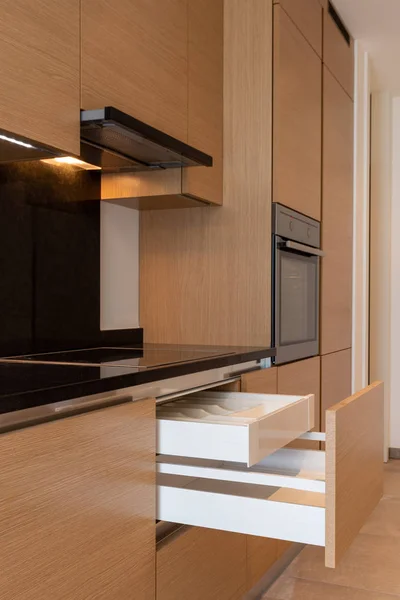 Kitchen detail with stove, hood and open drawers — Stock Photo, Image