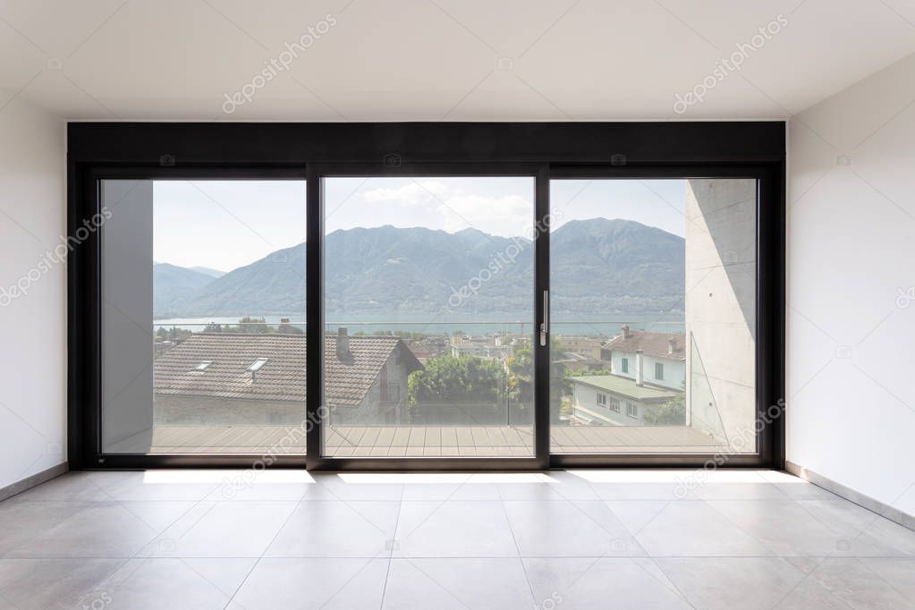 Room with black window overlooking Lake Maggiore