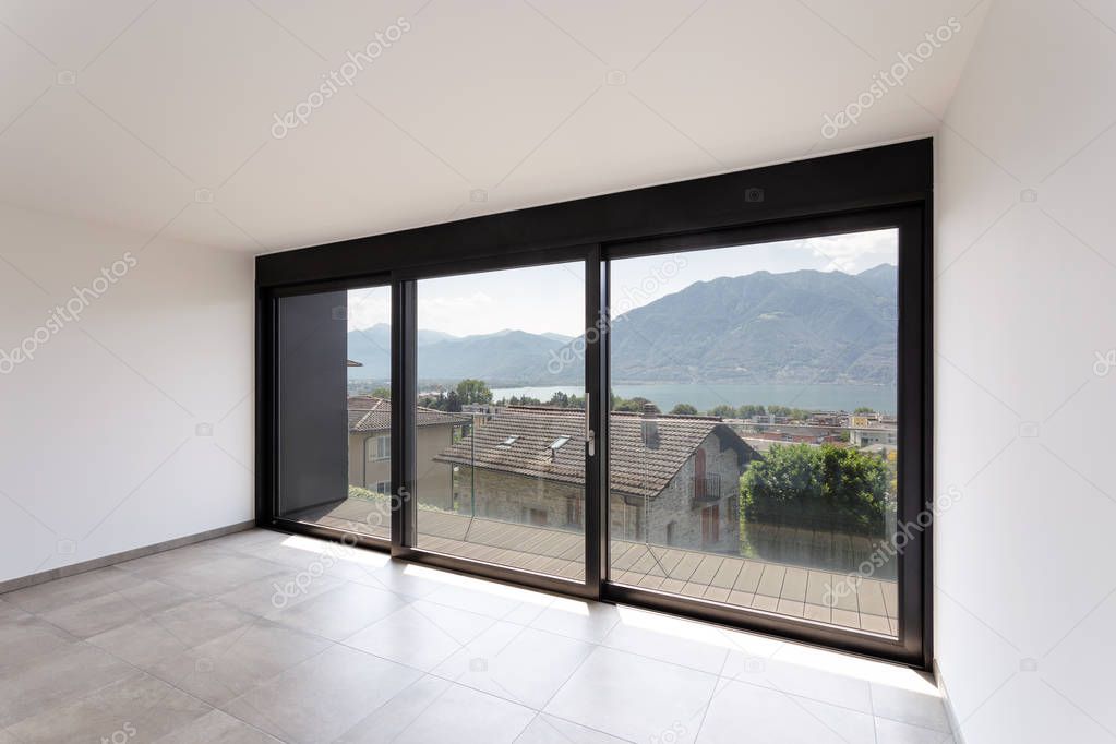 Room with black window overlooking Lake Maggiore