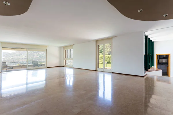 Empty living room with windows and lake view