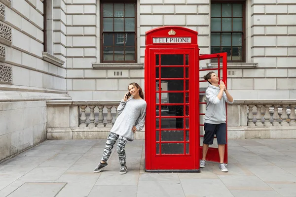 Two boys and a telephone box in London — Stock Photo, Image