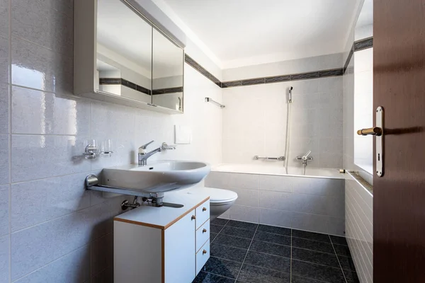 Bathroom with black tiles and large bathtub — Stock Photo, Image