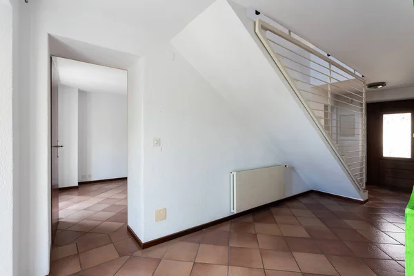 Corridor with terracotta floor and window