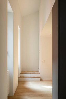 Front view corridor with white walls, two entrance steps and bri