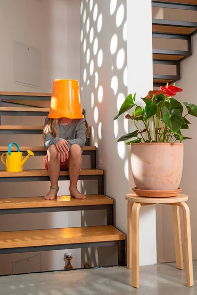 Little Girl Bucket Her Head Takes Care Flowers Her Home — Stock Photo, Image