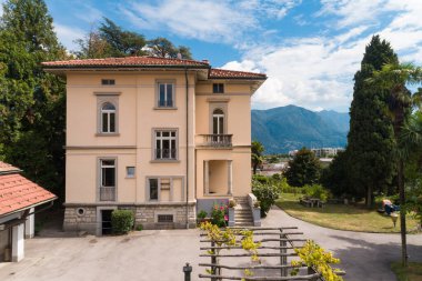 Güneşli bir yaz gününde büyük bir bahçesi olan büyük ve eski bir villa.