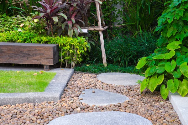 wood chair in the garden, view of garden patio, peaceful Garden with a Freshly Lawn.