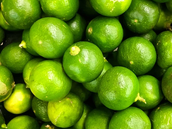 Green lemons background, Fruit in the market.