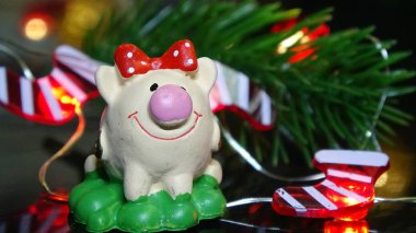 Domuz oyuncak ve kış dekor, tebrikler tatilde. Noel ışıkları arka plan üzerinde domuz yılı sembolü