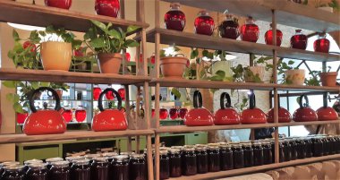 Cam kavanozlarda konserve meyve içer. Kavanoz çilek kompostosu. Komposto bir ahşap raf, birkaç renkli kutular. Seçici odak. Sığ derinlik-in tarla.