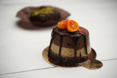 Güzel tasarımcı çikolatalı kek masanın üzerinde duruyor. Lezzetli ev yapımı tatlılar Şef tarafından iyi görünüyor.