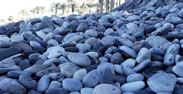 Primer plano de los guijarros marinos. Fondo de guijarros de playa de diferente forma y tamaño —  Fotos de Stock