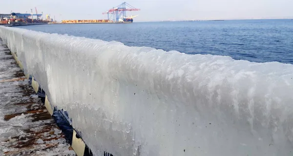 Mrożone sople wody morskiej. Lodowate poręcze nasypu w Odessie, Ukraina. Sopel zimne morze zima — Zdjęcie stockowe
