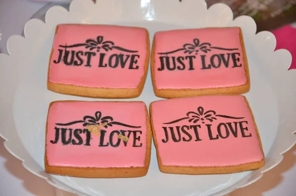 Just love on four pink cookies