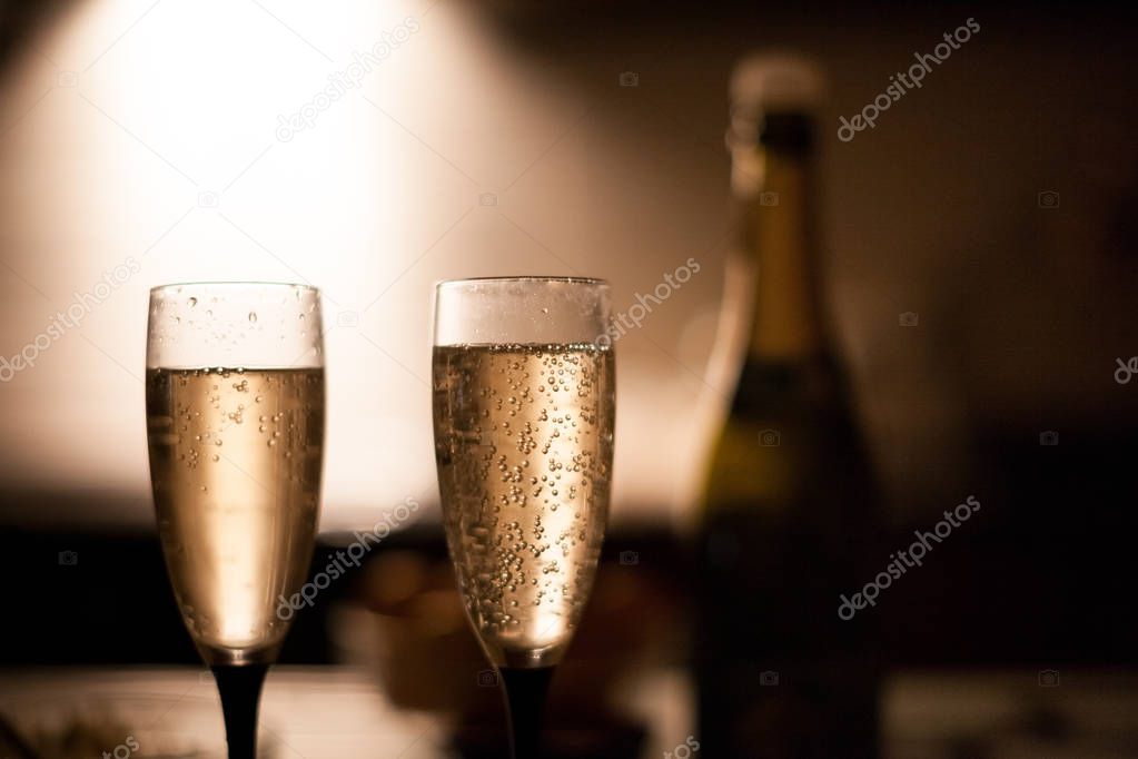 Two elegant champagne glasses on a dark surface on the kitchen !