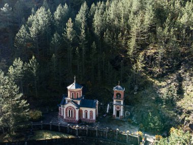 Tara Dağları 'ndaki Ortodoks Kilisesi. Sırbistan' da güneş ışığı ve taş çan kulesi var. g.