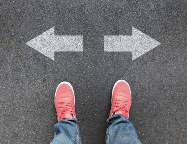 Asfalt yol üzerinde ayak ve farklı yön okları üstten görünüm