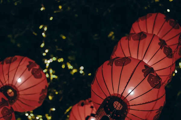 Chinese lamps flying away in night sky, Guangzhou, China.