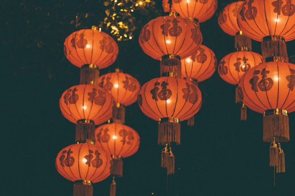 Chinese lamps flying away in night sky, Guangzhou, China.