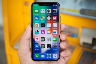 Koh Samui, Tayland - 25 Mart 2018: Ana ekran IOS ile iphone X tutan adam el. iPhone 10 oluşturuldu ve Apple Inc tarafından geliştirildi.