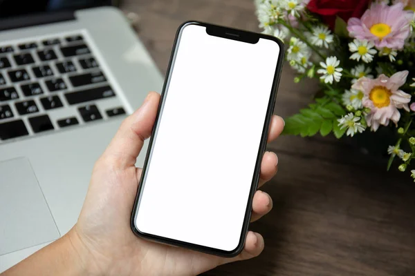 Female Hand Holding Phone Isolated Screen Desk Laptop Flowers — Stock Photo, Image