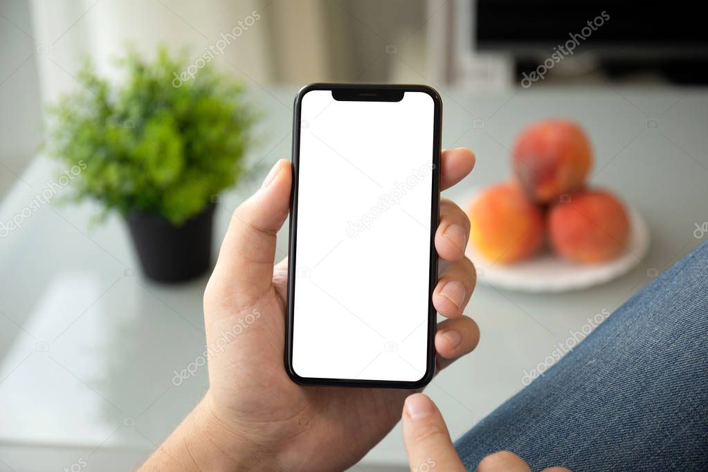 man hands holding phone with isolated screen in room of the house