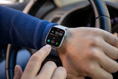 Aluşta, Rusya - 4 Kasım 2018: Adam el Apple Watch serisi 4 ve app kutsal kişilerin resmi üstünde belgili tanımlık perde ile arabada. Apple Watch oluşturuldu ve Apple Inc tarafından geliştirildi.