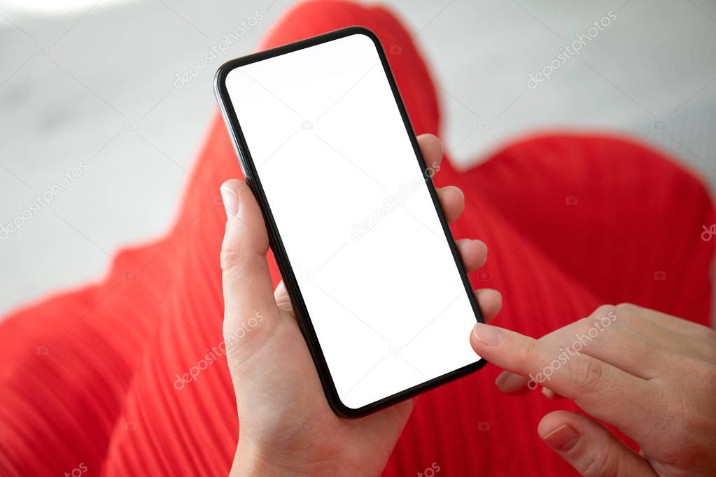 female hands in red dress holding phone with an isolated screen
