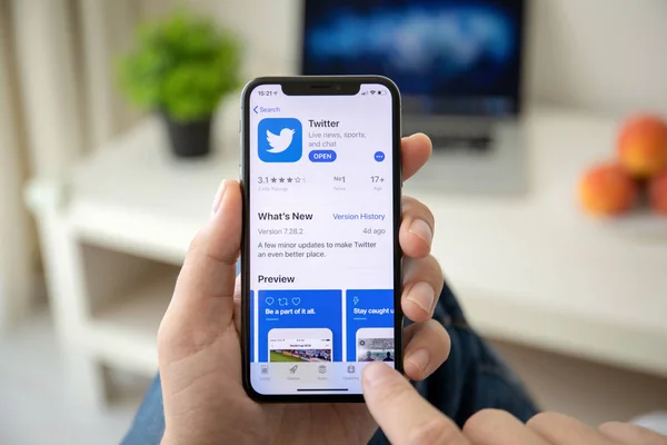 Man hand holding iPhone X with social networking service Twitter — Stok Foto