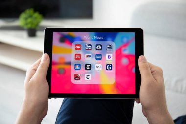 Adam el iPad Pro popüler Haberler uygulamaları ile tutarak