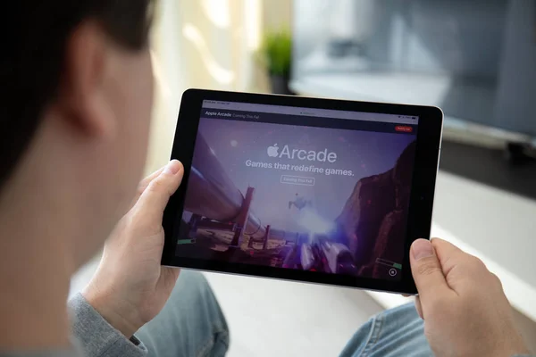 Przytrzymanie ipad Apple Arcade gry wideo subskrypcji servi ręka człowieka — Zdjęcie stockowe