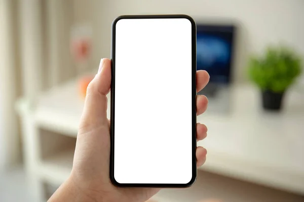 Female hands holding phone with isolated screen in the room — Stock Photo, Image