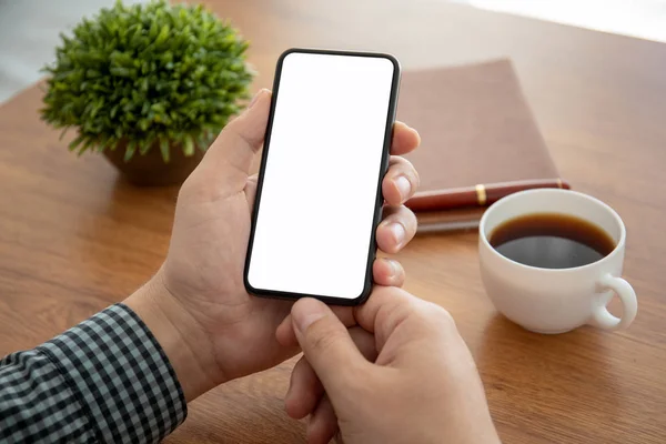 Male hand holding phone with isolated screen in the office — Stock Photo, Image