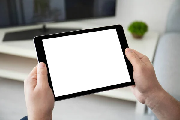 Man handen houden computer tablet met geïsoleerd scherm in de kamer — Stockfoto