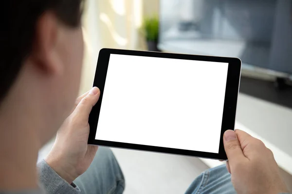 Man hands holding computer tablet with isolated screen in room — Stock Photo, Image