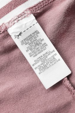 Pembe Tekstil arka plan closeup Composotion ve bakım kıyafet etikette