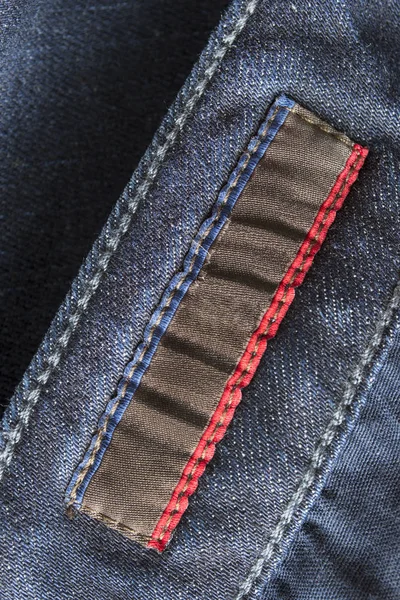 Blank Brown Textile Clothes Label Blue Denim Background Closeup — Stock Photo, Image