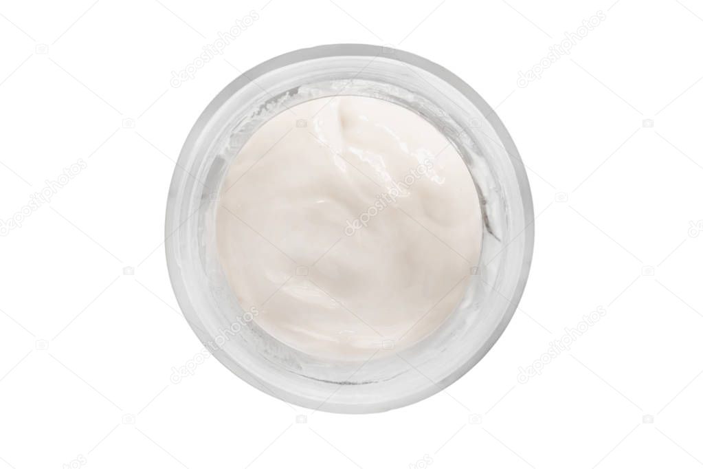 White face cream in a round glass jar isolated over white