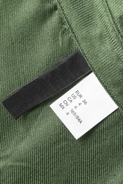 36 size clothes label on khaki green textile background