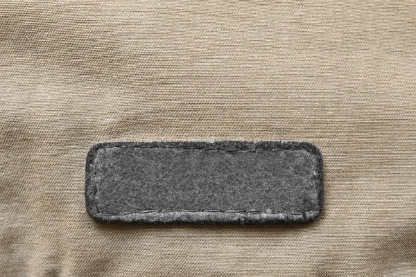 Blank Black Patch Beige Textile Background Closeup — Stock Photo, Image