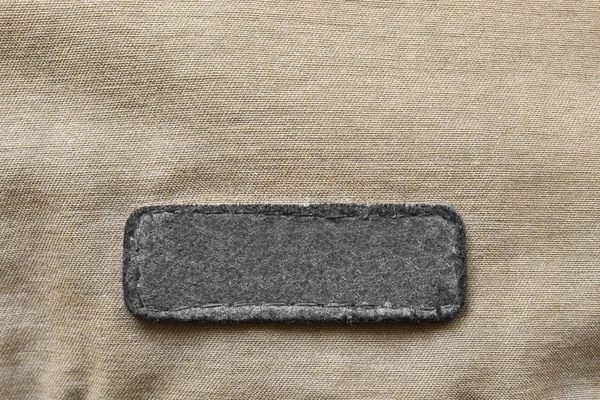 Parche Negro Blanco Sobre Fondo Textil Beige — Foto de Stock