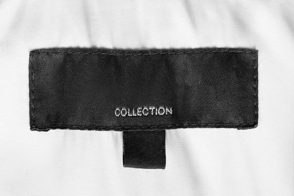 Etiqueta Ropa Negra Dice Colección Sobre Fondo Textil Blanco — Foto de Stock