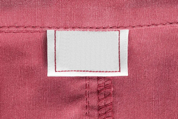 Lege Textiel Kleding Label Roze Katoenen Achtergrond Closeup — Stockfoto