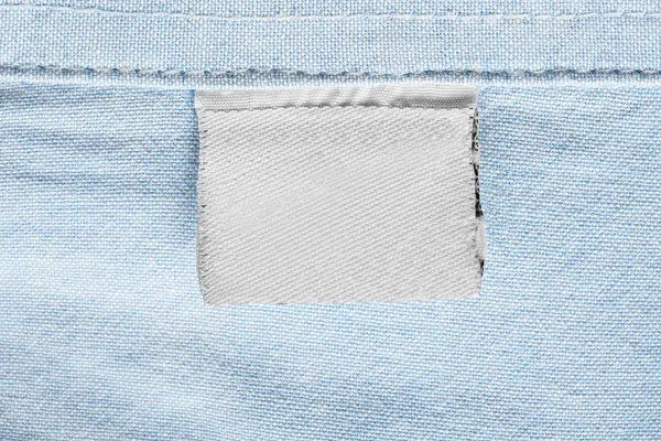 Blank Textile White Clothes Label Blue Cotton Background — Stock Photo, Image