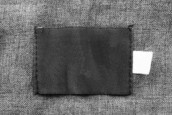 灰色纺织背景特写黑色空白纺织品补丁 — 图库照片