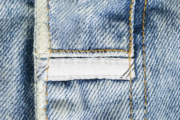 White Blank Textile Clothes Label Blue Denim Background — Stock Photo, Image