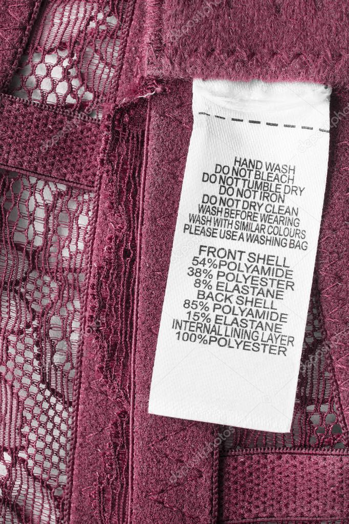 Composition and care clothes label on pink lacy background