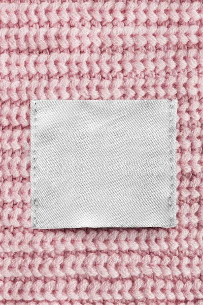 Etiqueta Ropa Textil Blanco Sobre Fondo Punto Rosa Cerca —  Fotos de Stock