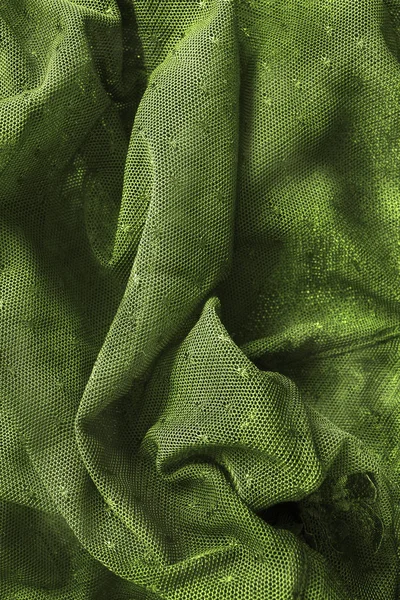 Draped groene textiel achtergrond — Stockfoto