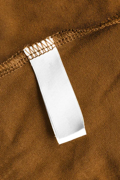 Etichetta Abbigliamento Bianco Sfondo Tessile Marrone — Foto Stock